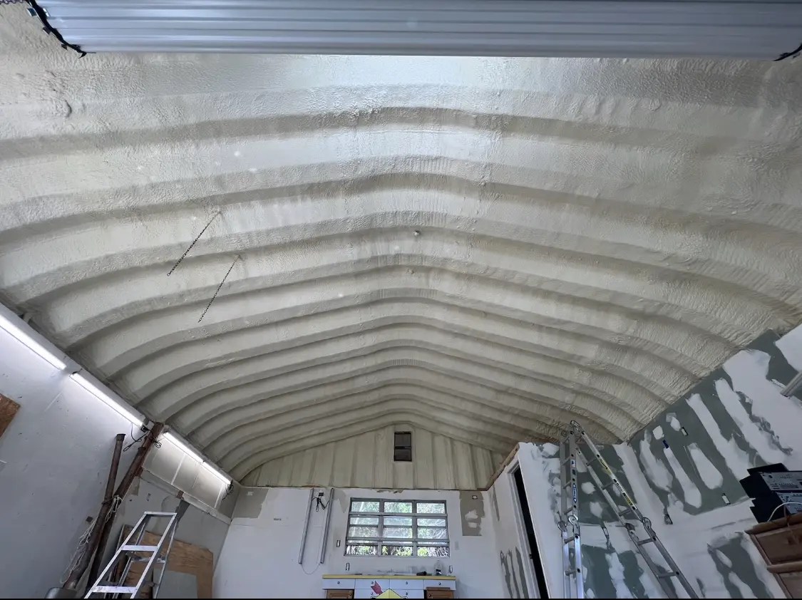 Spray polyurethane foam applied to the underside of a metal roof deck in Robinwood